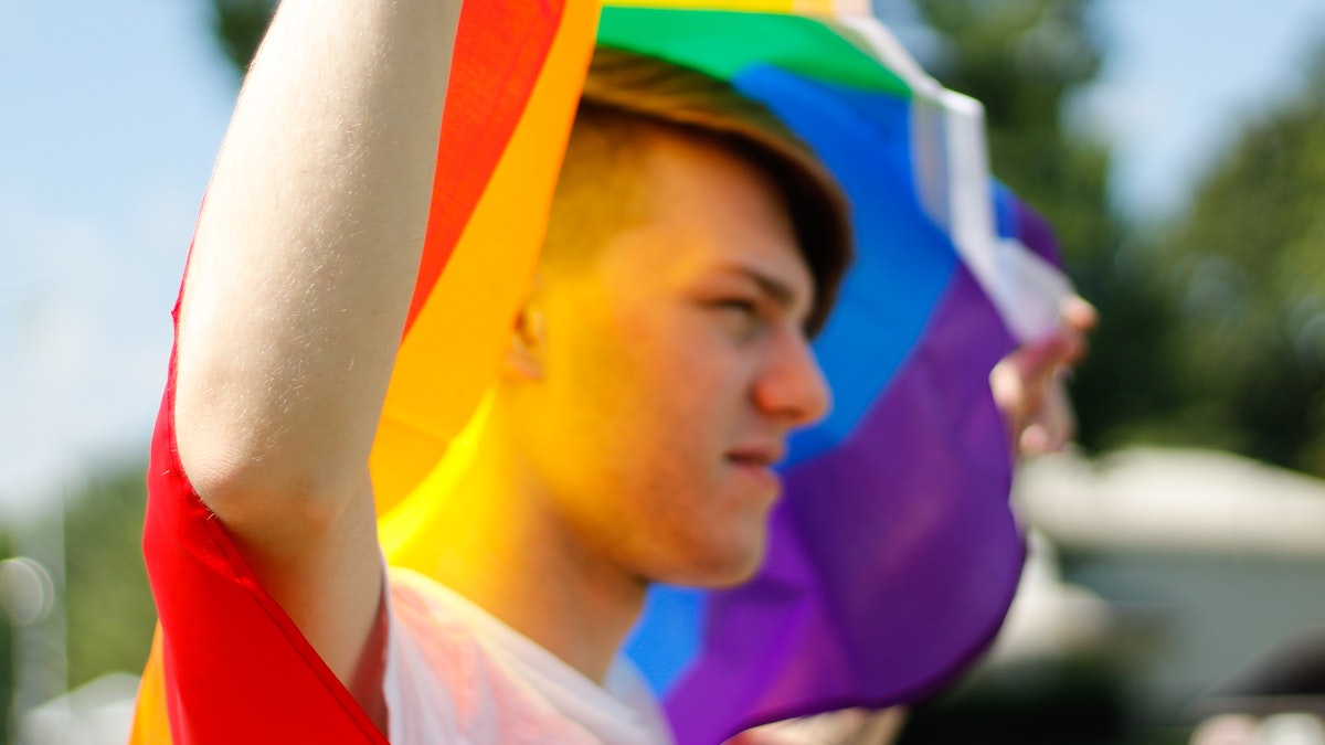 teen holding pride flag
