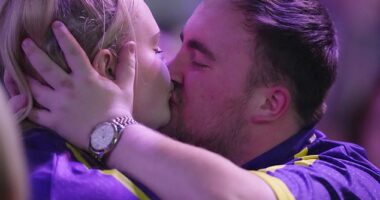 Teenage darts sensation Luke Littler was seen getting a peck from a mystery blonde after his victory at the World Darts Championship today