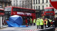 Police and emergency service crews surround a bus that crashed into a pedestrian outside London Victoria Bus Station