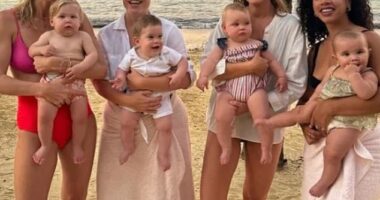 Hello 2024! Princess Eugenie, 33, (second left) holds six-month-old Ernest as she poses for a sunset shot with friends on a beach in Jamaica