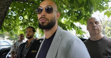 Andrew Tate (centre) and brother Tristan (left) leave Romania's Court of Appeal in August. The pair face charges of rape