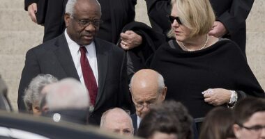 Supreme Court Associate Justice Clarence Thomas, left and his wife Virginia Thomas, right, after Justice Antonin Scalia's funeral in 2016