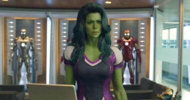 She-Hulk standing in an office with various Iron Man suits behind her