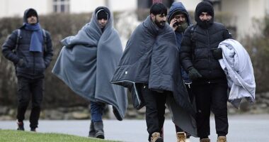 Migrants walk through the French coastal commune of Wimereux on Wednesday afternoon after an aborted attempt to cross the channel