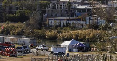 Texas Department of Public Safety officers work inside a fenced off Shelby Park, Thursday. The park lies in a major corridor for migrants entering illegally from Mexico and is the center of Abbott's aggressive attempts to stop them, known as Operation Lone Star