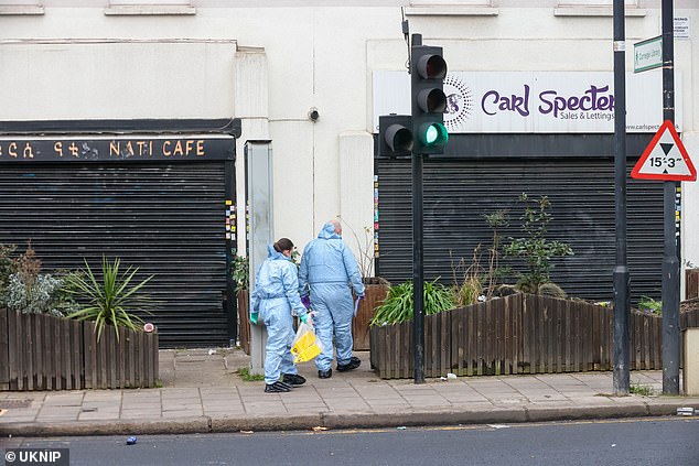 Forensic teams in Coldharbour Lane, Brixton, this morning after a woman and man were shot in a 'fight'. Two other men were also injured - one stabbed and the one assaulted