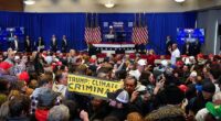 Climate activists interrupted Donald Trump's rally in Indianola, Iowa on Sunday with signs accusing the former president of being a 'climate cirminal'