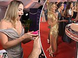 AACTA Awards 2024: Adorable moment Margot Robbie accepts a packet of Tim Tams on the red carpet - while Elsa Pataky politely declines the treats