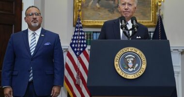 Education Secretary Miguel Cardona standing alongside President Biden at the White House. The new draft proposal includes multiple factors the secretary may consider to determine whether borrowers are facing financial hardship that would qualify them for student loan relief