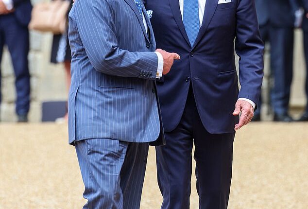 President Joe Biden said he is 'concerned' about King Charles III after Buckingham Palace revealed he has been diagnosed with cancer. They are pictured together at Windsor Castle in July last year