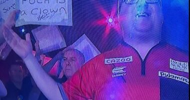 Fans were seen holding up banners that read 'Poch is a clown' at the Cazoo Darts Masters on Sunday