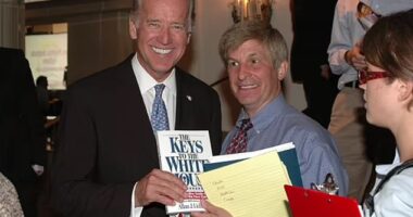 Joe Biden is seen with Allan Lichtman, holding a copy of his book. Lichtman believes the signs show 2024 trending Biden's way