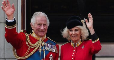 King Charles and Queen Camilla wave from the balcony of Buckingham Palace
