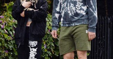 Joe Manganiello and his girlfriend Caitlin O'Connor, 33, bundled up in rain gear to venture out for a walk during the storm that has been flooding Los Angeles