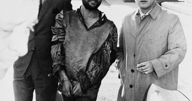 Bruce Davis, now 81, a member of Charles Manson's murderous cult, has had his parole hearing postponed after he appeared on a true crime podcast. Pictured: Davis (left) with his attorney outside the Hall of Justice in 1969 after his arrest