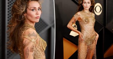Miley Cyrus sports barely-there gold dress and teased hair on the Grammys 2024 red carpet