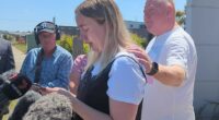 Mick Murphy comforts his daughter Jess during a press conference in Ballarat West on Thursday