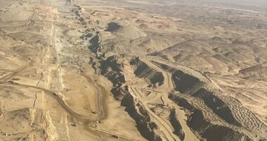 The new images reveal a vast chasm (pictured) that was carved through the mountains in preparation for the 75-mile-long horizontal skyscraper mega-project