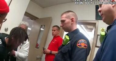 Police and medics talk with the student