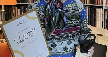 The former Queen Margrethe II (pictured) shows off the design award she won for her work on a Netflix movie