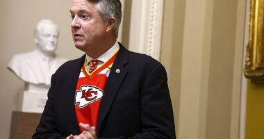 Senator Roger Marshall wearing Kansas City Chiefs jersey as he speaks on Capitol Hill