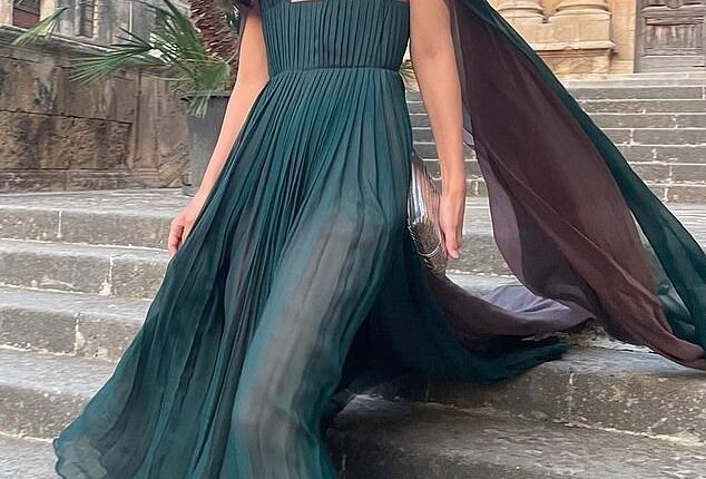 Alessandra exudes glamour in a emerald green cape dress by Dior