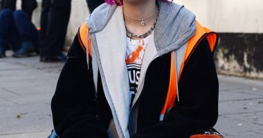 Phoebe Plummer sits in the middle of the street as police surround her