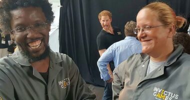 Happy as Harry! The Duke of Sussex let his silly side show as he stuck his tongue out behind two Invictus Games workers in this snap taken in Toronto