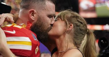 Taylor Swift kisses Kansas City Chiefs tight end Travis Kelce after the team's victory