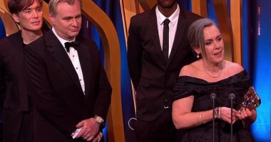 The influencer known as Lizwani, second right, is pictured on stage at the BAFTAs behind Oppenheiemer producer Emma Thomas, as well as Cillian Murphy and Christopher Nolan