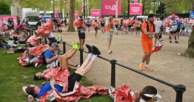 London Marathon runners stretch out as they recover from taking part in the world famous event