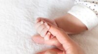 baby holding finger