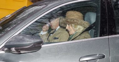 Queen Camilla is pictured smiling as she sits next to her husband after attending a church service together