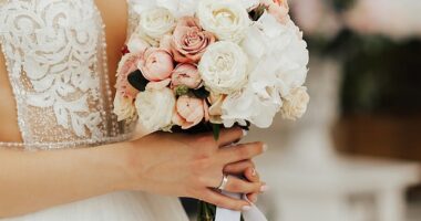 Wedding flowers can cost hundreds from a pro florist, but having a go at growing your own blooms is one way to make your big day feel super personal - and cut costs (Stock image of a bride holding up her wedding bouquet)