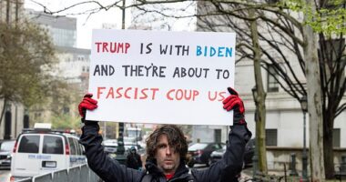 Max Azzarello, a 37-year-old from St. Augustine, Florida , is seen holding a sign a outside the Manhattan criminal courthouse on April 18 in the image