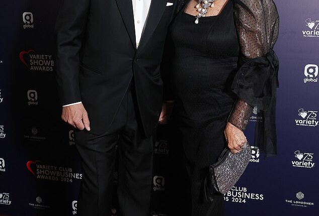 Dame Joan Collins cut a glamorous figure as she stepped out to the Variety Club Showbusiness Awards with her husband Percy Gibson at The Londoner Hotel in the UK capital on Sunday