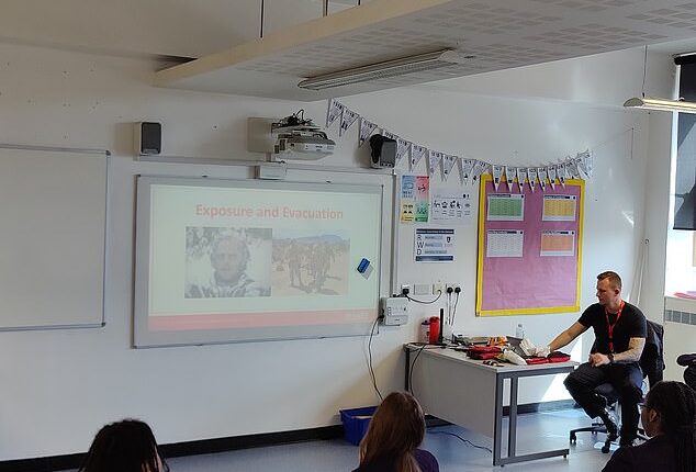 Year nine pupils at the City of London Academy pictured being taught how to treat stab and gunshot wounds by a City of London Police officer