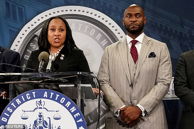 Nathan Wade and Fani Willis are pictured in August 2023. He now faces an accusation of contempt of court