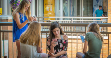kids sitting around on their phones