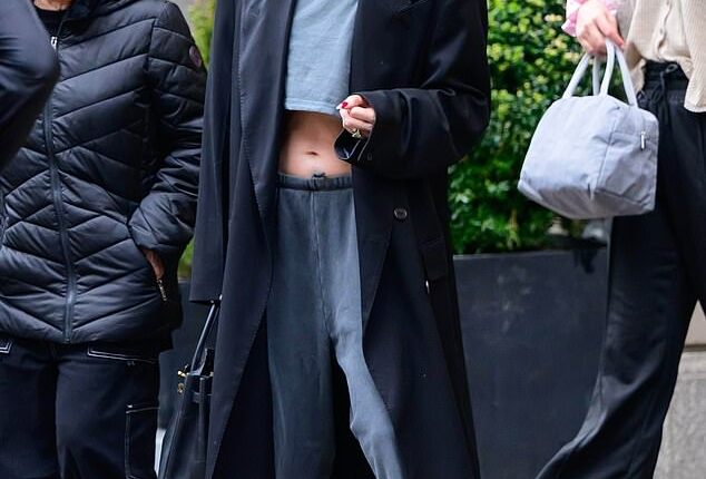 Jennifer Lopez showed off her enviable abs in a tiny grey crop top and a pair of low-rise sweatpants while stepping out of her luxurious New York City penthouse