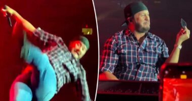 Luke Bryan falls on stage after slipping on fan’s cell phone