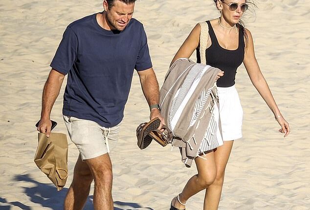 Michelle Keegan and Mark Wright appeared to be enjoying themselves on the beach in Sydney as they packed on the public displays of affection this week