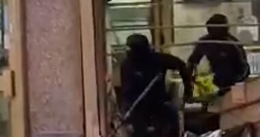 Moment masked robbers armed with sledgehammers steal thousands of pounds in valuables after smashing through Leeds jewellers in 4x4 before making their getaway in black Audi - as police launch desperate hunt for gang