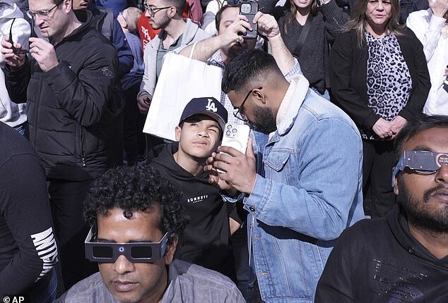 About 100 individuals in the US and Canada reported eclipse-related retina damage to doctors after the August 21, 2017 solar eclipse, according to the American Astronomical Society. Above, people view Monday's solar eclipse from Times Square in New York on April 8, 2024