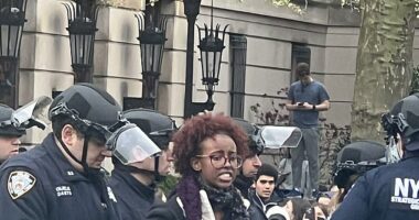 Isra Hirsi, Rep Ilhan Omar's daughter, is seen being handcuffed and arrested on Columbia's campus on Thursday. She has been taking part in an anti-Israel rally at the college