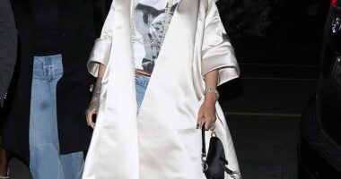 Rihanna exuded superstar glamour in a long white satin coat while enjoying a night in Los Angeles on Saturday