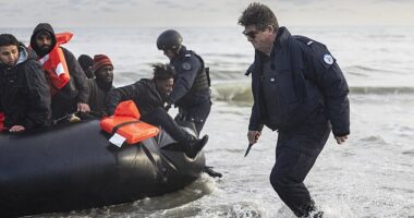 A French policeman slashes an inflatable dinghy filled with migrants in images showing a dramatic escalation of force against people smugglers
