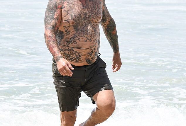 Married At First Sight groom Timothy Smith showed off his heavily tattooed physique as he enjoyed an ocean swim at Tamarama Beach in Sydney with two co-stars this week