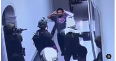 Shocking new footage shows FBI raid on Diddy's LA mansion as heavily-armed agents march his sons through house at gunpoint, pin them against walls and park armored tanks outside