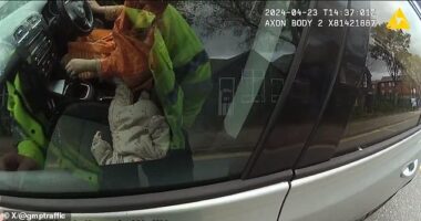 The image shared by Greater Manchester Police of the woman at the wheel - with a baby in the passenger seat, unrestrained